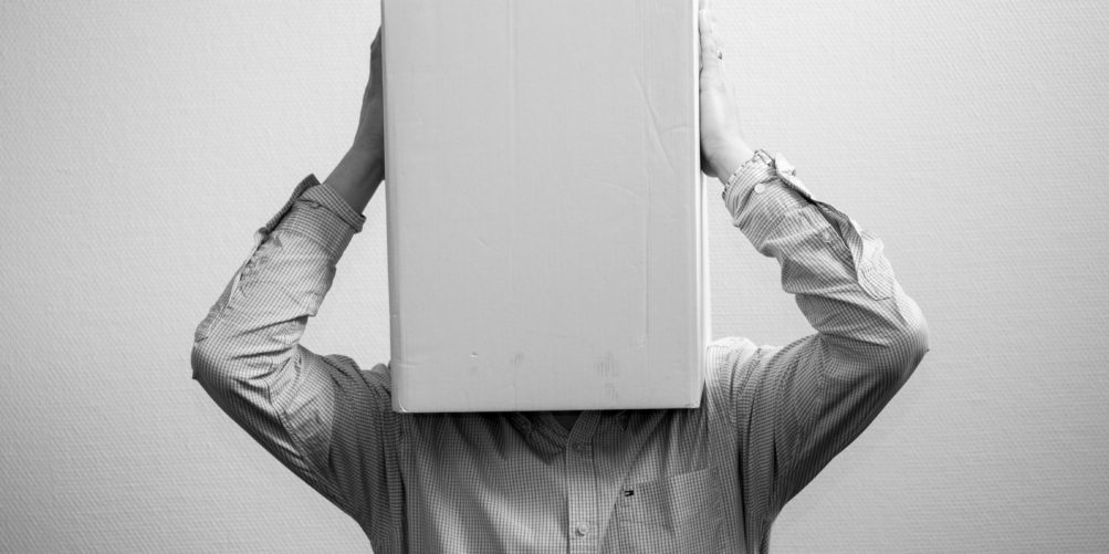 A person wearing a box on his head