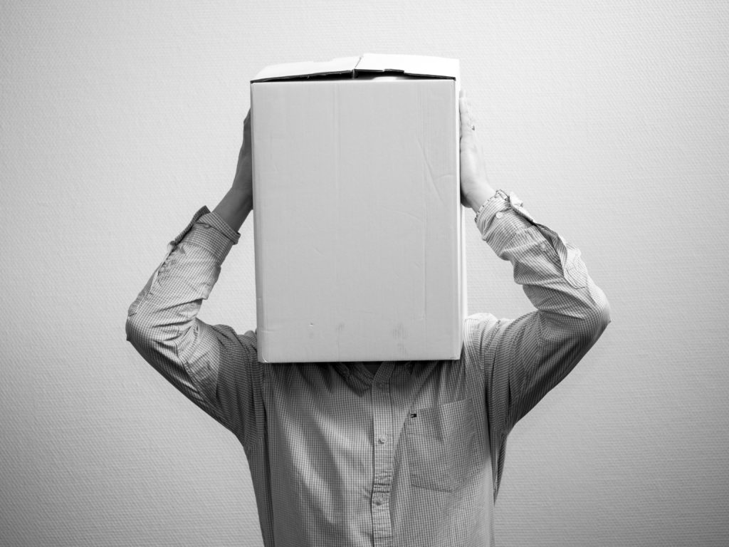 A person wearing a box on his head